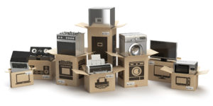 A group of open cardboard boxes holding various household appliances and electronics